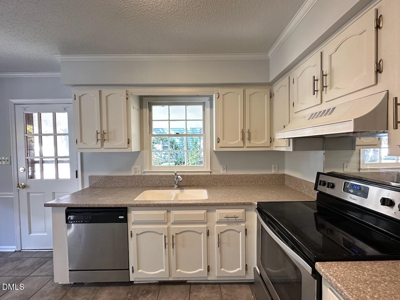 3717 Sue Ellen Drive Raleigh, NC 27604 - Photo 5 of 20 a kitchen with granite countertop a sink a stove and cabinets