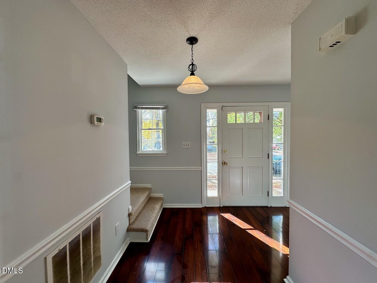 3717 Sue Ellen Drive Raleigh, NC 27604 - Photo 8 of 20 a hallway with wooden floor windows and stairs