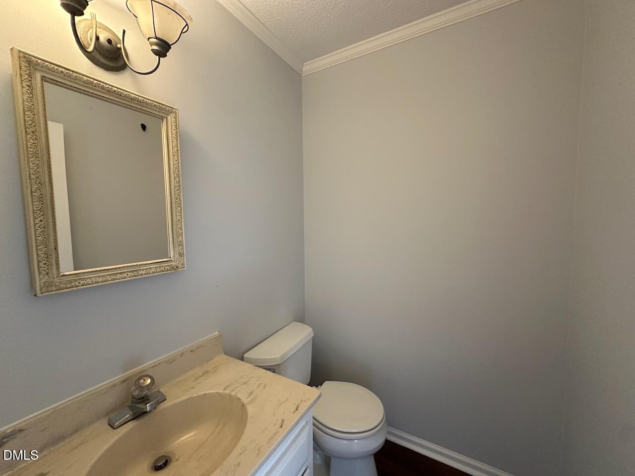 3717 Sue Ellen Drive Raleigh, NC 27604 - Photo 9 of 20 a white toilet sitting next to a bathroom sink