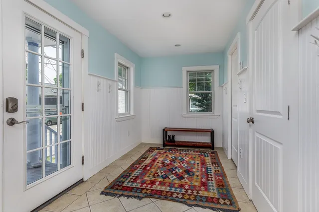 a bedroom with wooden floor and a window