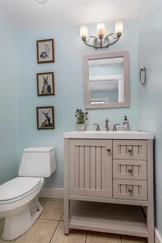 a bathroom with a toilet a sink and a mirror