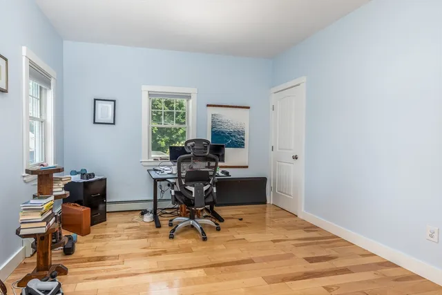 a view of a workspace with furniture and a window