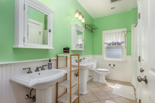 a bathroom with a sink toilet and mirror