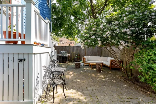 a view of a patio with table and chairs and potted plants