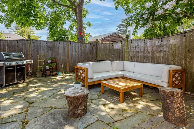 a view of a backyard with sitting area