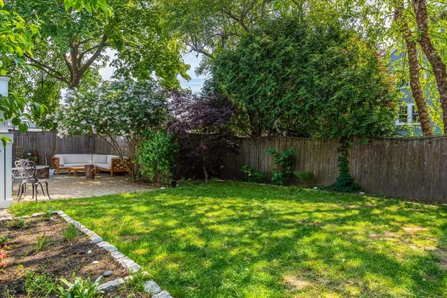 a view of a backyard with sitting area