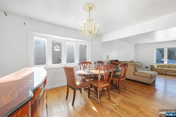 a view of a dining room with furniture wooden floor and chandelier