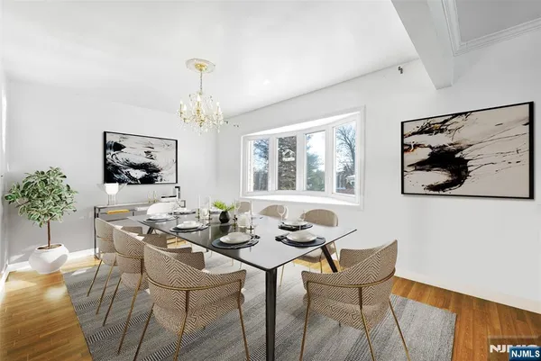 a dining room with furniture a rug and a chandelier