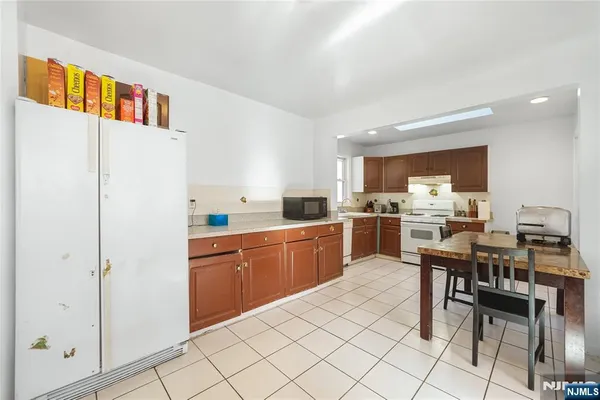 a kitchen with cabinets and chairs