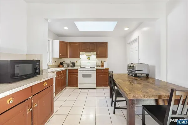 a kitchen with a stove a sink and a microwave
