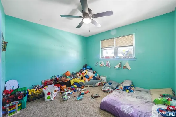 a bed room with toys and a window