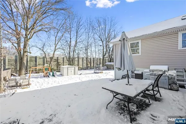 a view of a backyard with table and chairs
