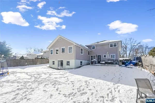 a view of a house with a snow in the background