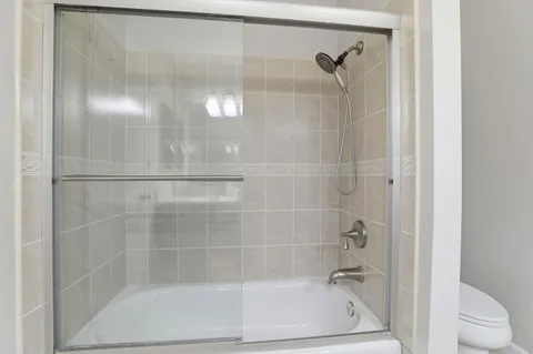 a bathroom with a glass shower door