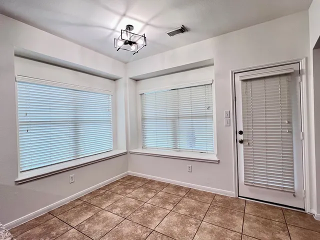 a view of an empty room with a window