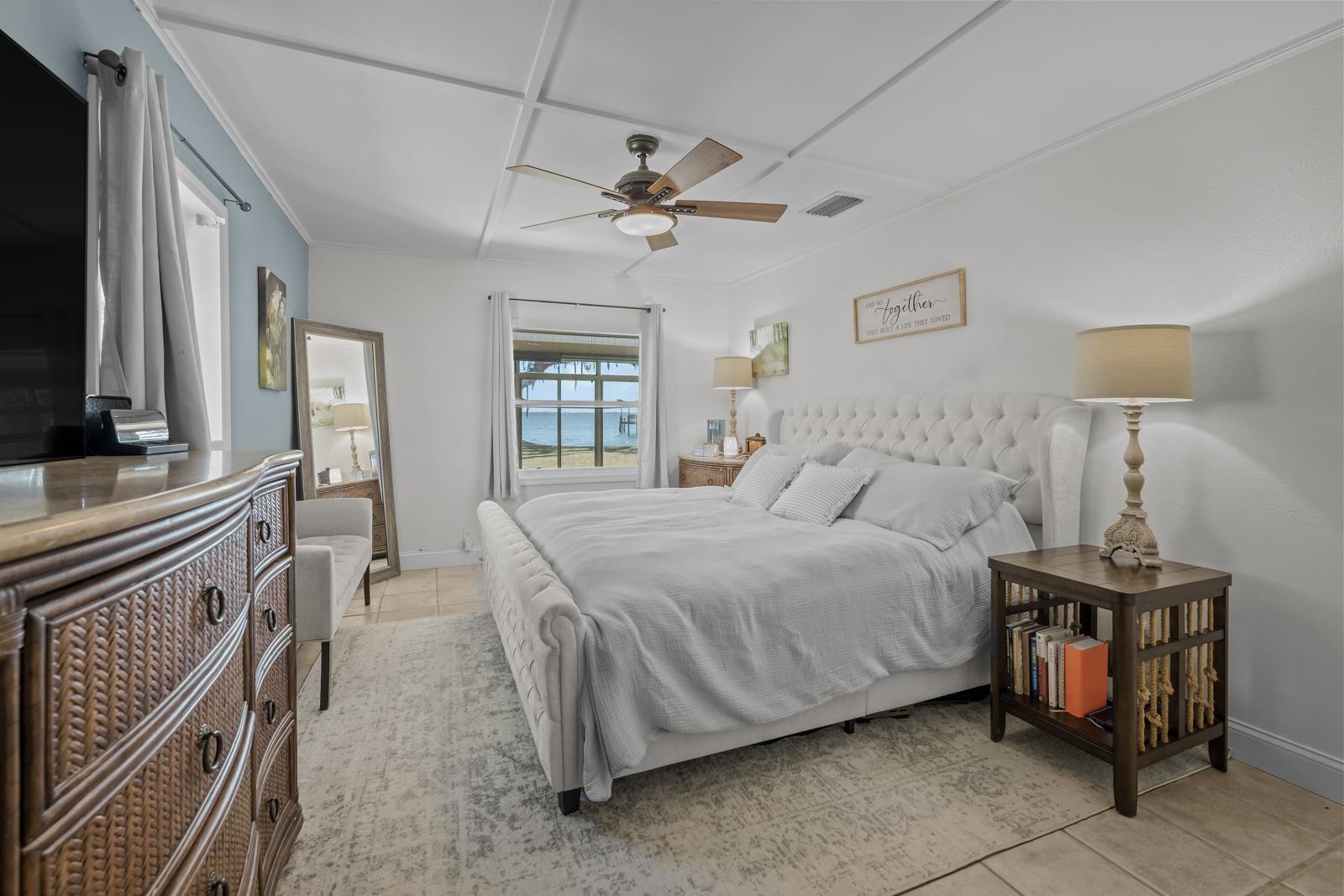 130 Cedar Creek Road Palatka, FL 32177 - Photo 17 of 73 a spacious bedroom with a bed a chandelier and flat screen tv