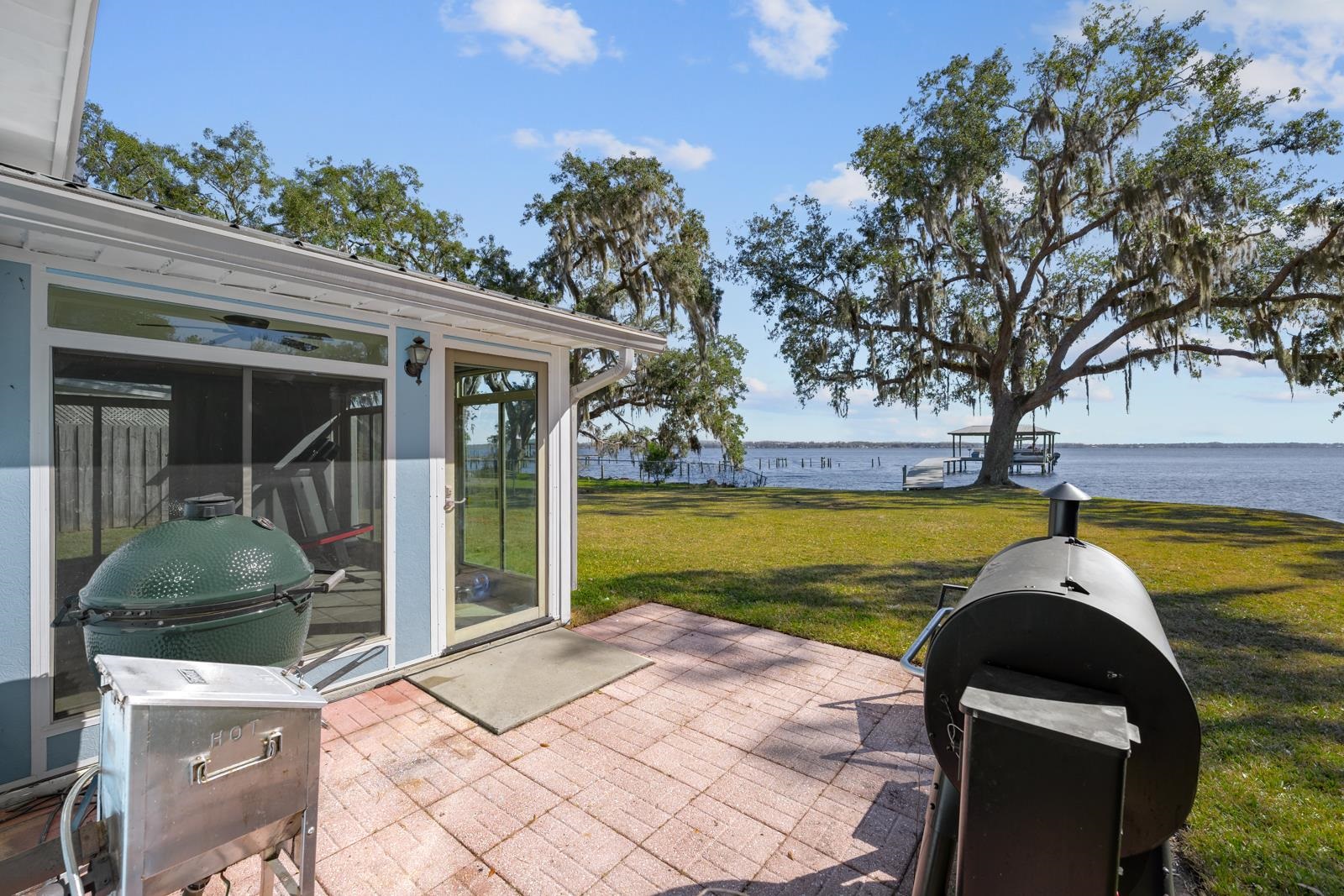 130 Cedar Creek Road Palatka, FL 32177 - Photo 25 of 73 View of patio / terrace featuring a water view, a sunroom, and grilling area