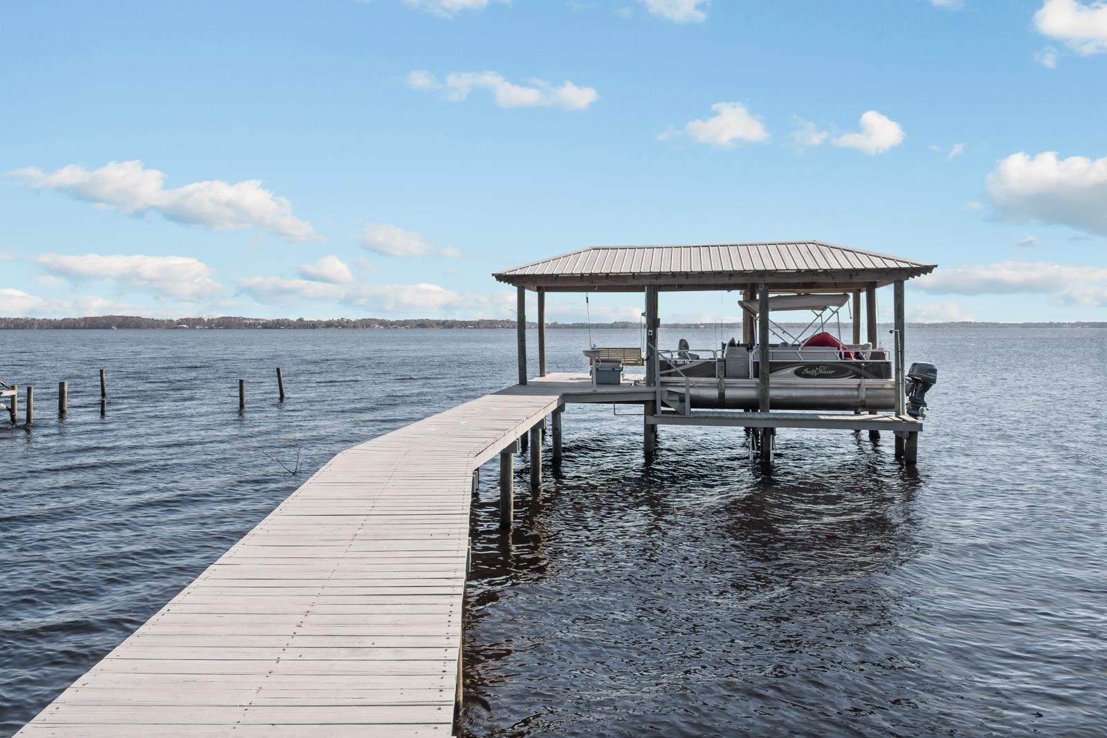 130 Cedar Creek Road Palatka, FL 32177 - Photo 31 of 73 a view of a roof deck with wooden floor and fence