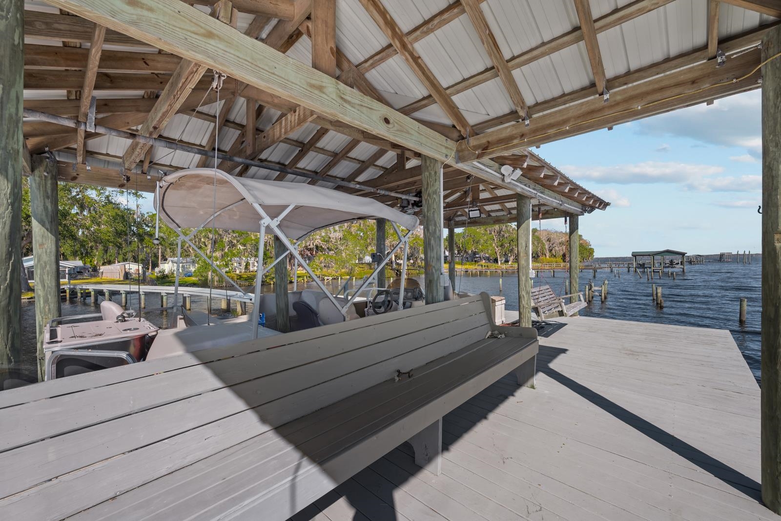 130 Cedar Creek Road Palatka, FL 32177 - Photo 35 of 73 a view of a patio with table and chairs with wooden floor