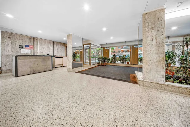 a view of a kitchen with refrigerator and a sink