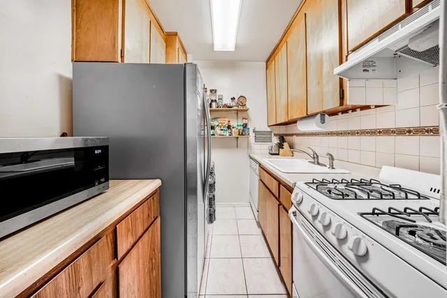a kitchen with stainless steel appliances granite countertop a stove and a refrigerator