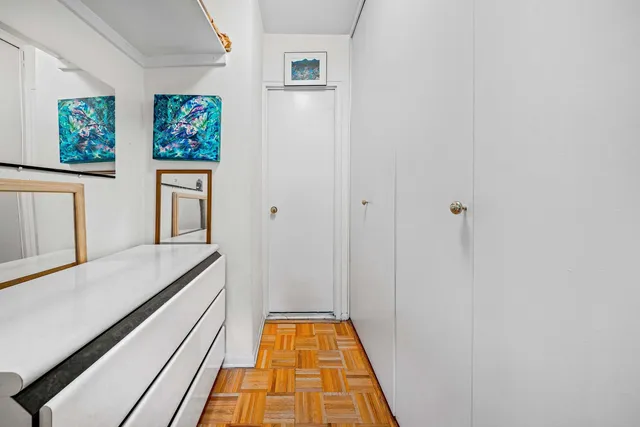 a bed room with a bed and painting on the wall