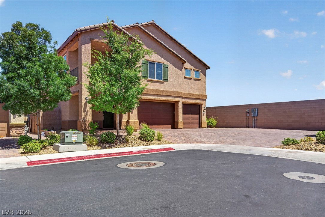1824 Redland Ridge Street Henderson, NV 89002 - Photo 69 of 69 A terracotta-tiled roof and stucco exterior enhance this home's curb appeal, complemented by a paver driveway.