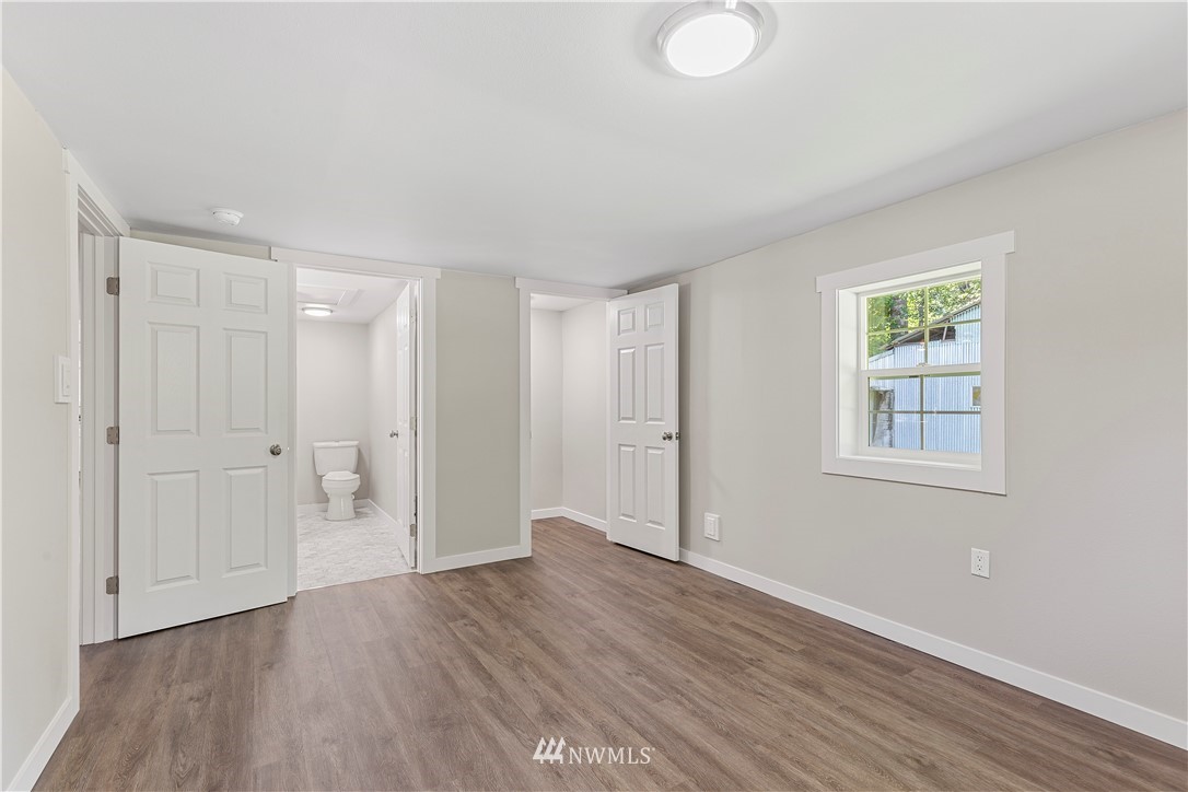 17610 Blodgett Road Mount Vernon, WA 98274 - Photo 22 of 30 a view of an empty room with wooden floor and a window