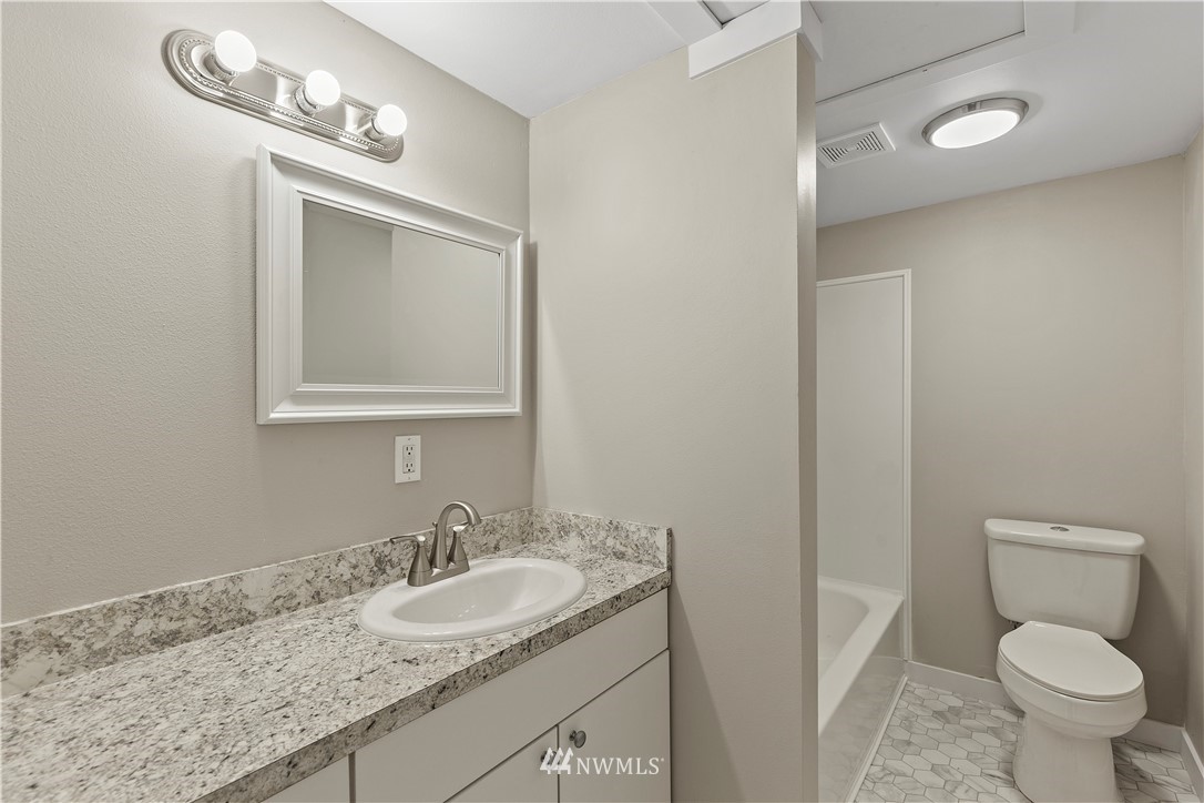 17610 Blodgett Road Mount Vernon, WA 98274 - Photo 24 of 30 a bathroom with a granite countertop toilet sink and mirror