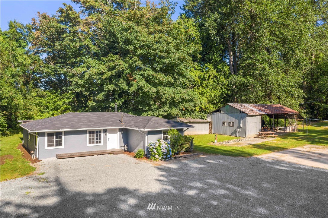 17610 Blodgett Road Mount Vernon, WA 98274 - Photo 25 of 30 a front view of a house with a yard and large trees