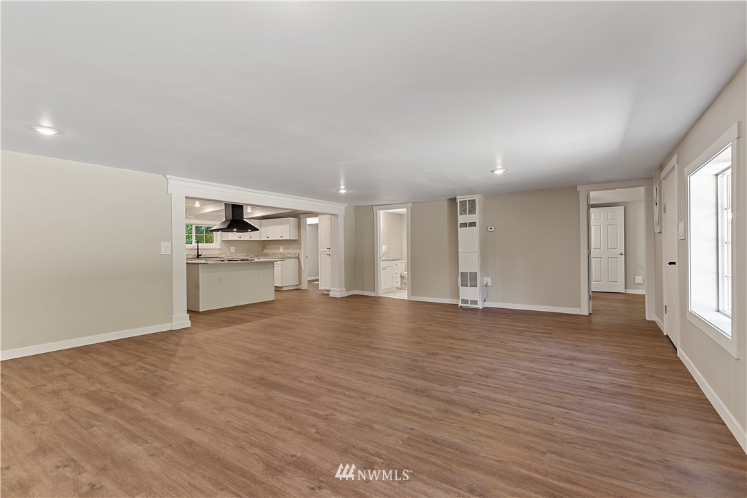17610 Blodgett Road Mount Vernon, WA 98274 - Photo 4 of 30 an empty room with wooden floor cabinet and windows