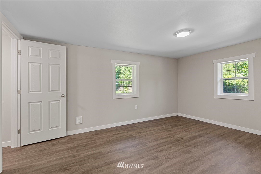17610 Blodgett Road Mount Vernon, WA 98274 - Photo 6 of 30 a view of an empty room with wooden floor and a window