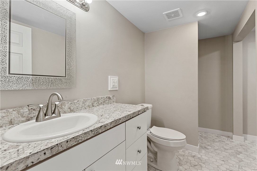 17610 Blodgett Road Mount Vernon, WA 98274 - Photo 7 of 30 a bathroom with a granite countertop sink a toilet and a mirror