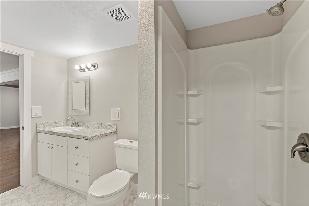 17610 Blodgett Road Mount Vernon, WA 98274 - Photo 9 of 30 a bathroom with a granite countertop sink toilet and shower