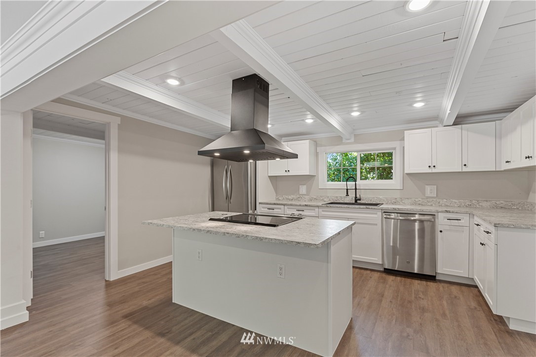 17610 Blodgett Road Mount Vernon, WA 98274 - Photo 10 of 30 a kitchen with stainless steel appliances granite countertop a sink a stove and a wooden floors