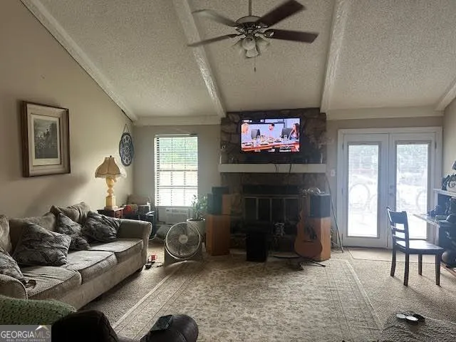 a living room with furniture a fireplace and a flat screen tv