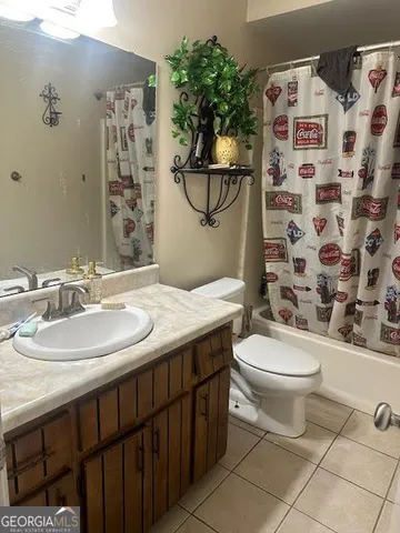 a bathroom with a sink a toilet and shower curtain