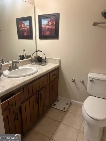a bathroom with a toilet a sink and mirror
