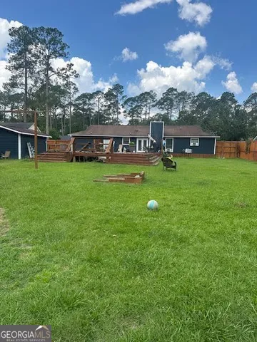 a front view of house with yard and trampoline