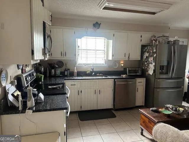 a kitchen with a refrigerator and a sink