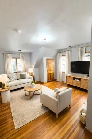 a bedroom with furniture and a flat screen tv