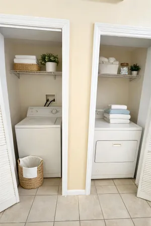 a utility room with cabinets washer and dryer