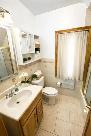 a bathroom with a sink toilet and mirror