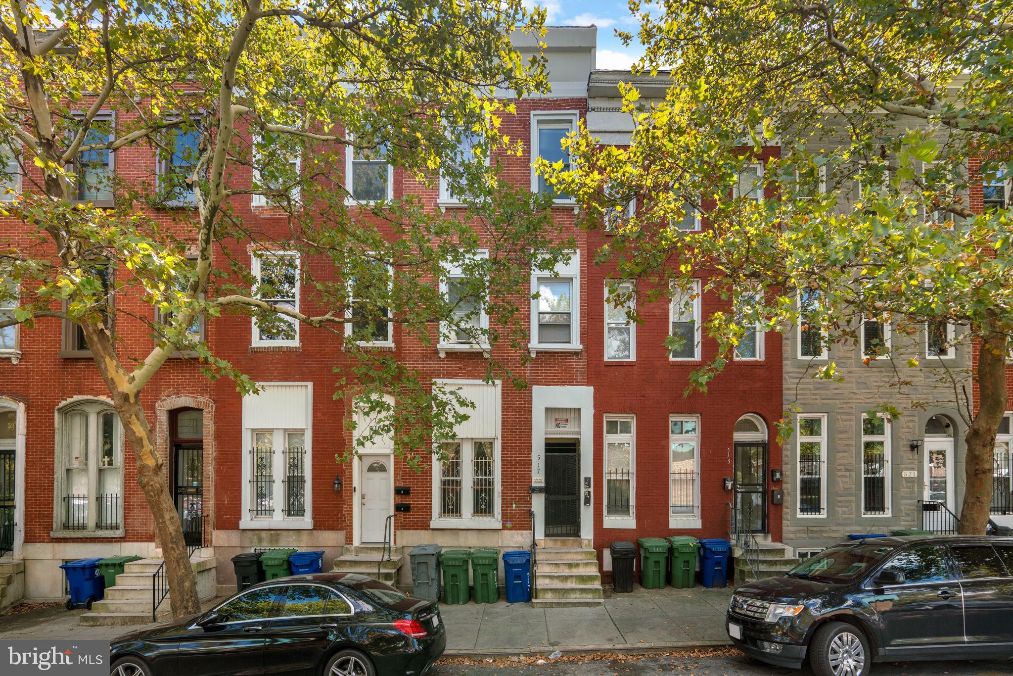 517 Mosher Street Baltimore, MD 21217 - Photo 1 of 45 a city street lined with buildings and cars