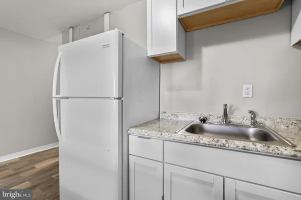 a white refrigerator freezer sitting inside of a kitchen