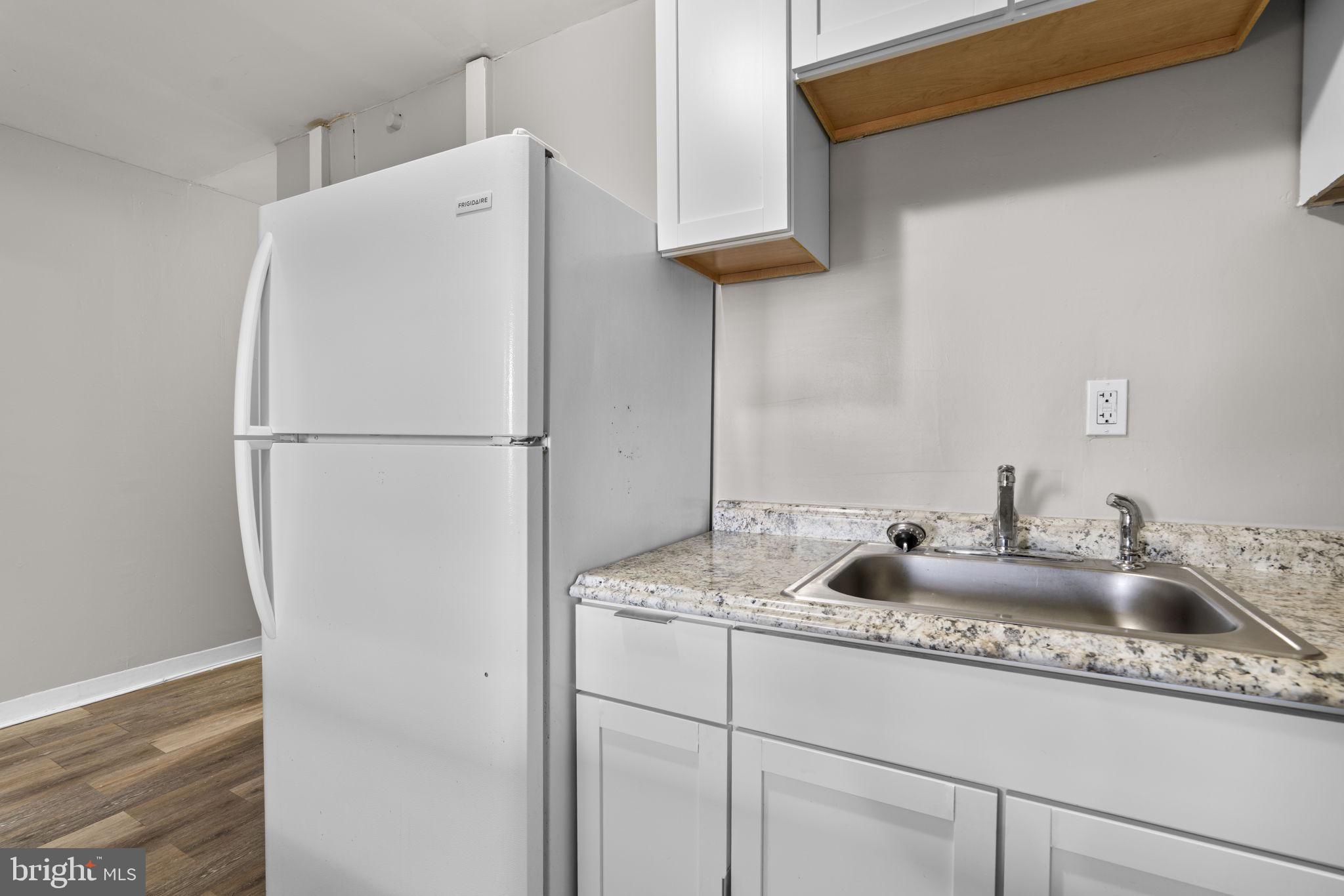 517 Mosher Street Baltimore, MD 21217 - Photo 11 of 45 a white refrigerator freezer sitting inside of a kitchen