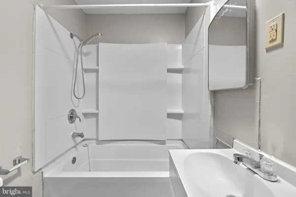 a bathroom with a tub and a sink