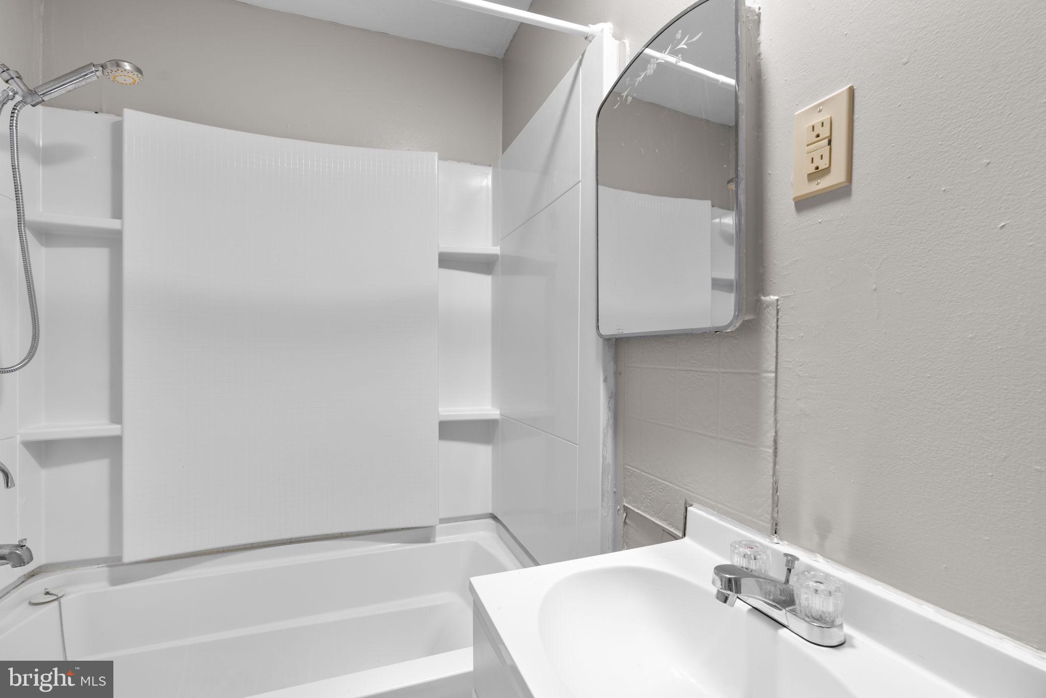 517 Mosher Street Baltimore, MD 21217 - Photo 13 of 45 a bathroom with a sink and a mirror