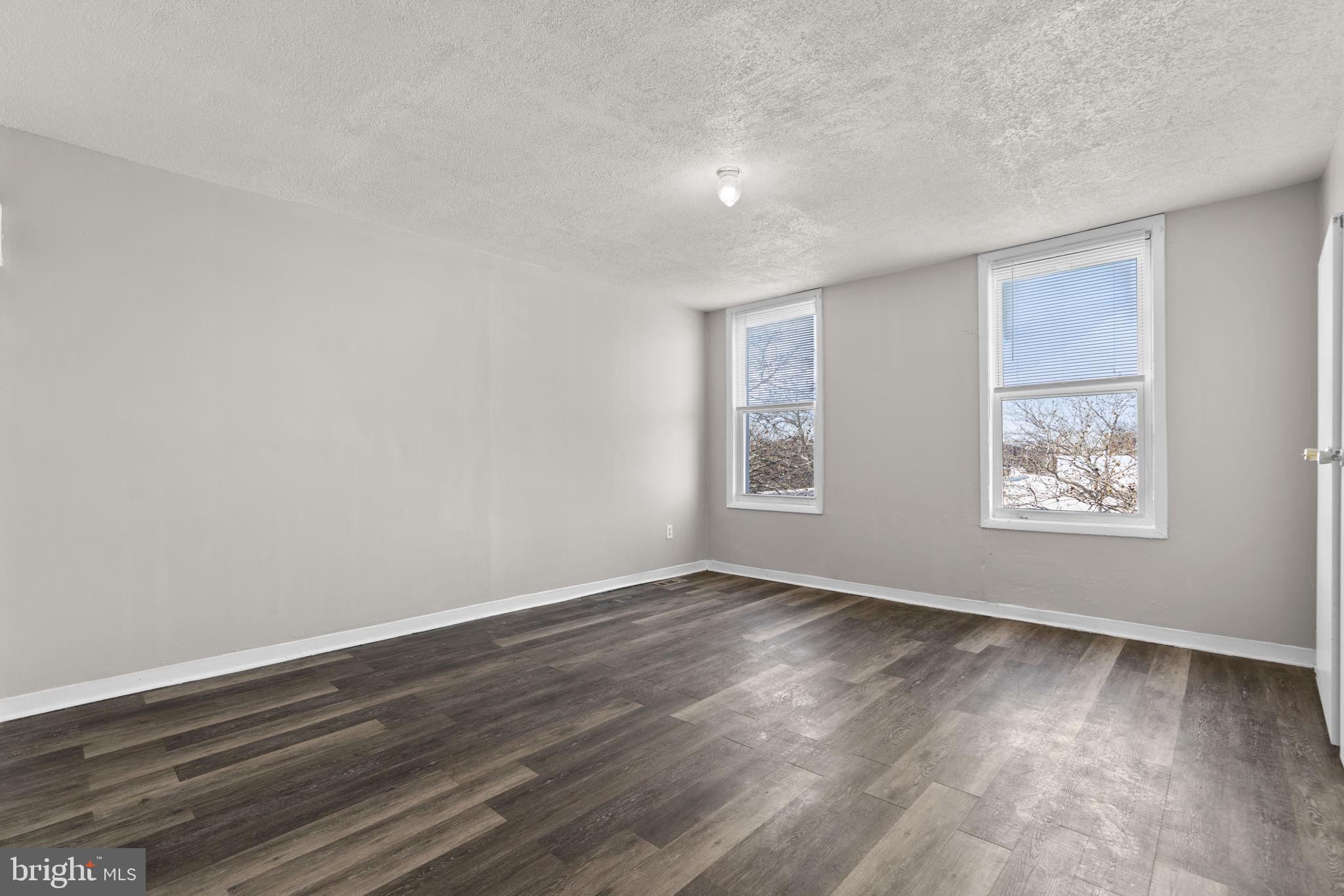 517 Mosher Street Baltimore, MD 21217 - Photo 14 of 45 a view of an empty room with wooden floor and a window