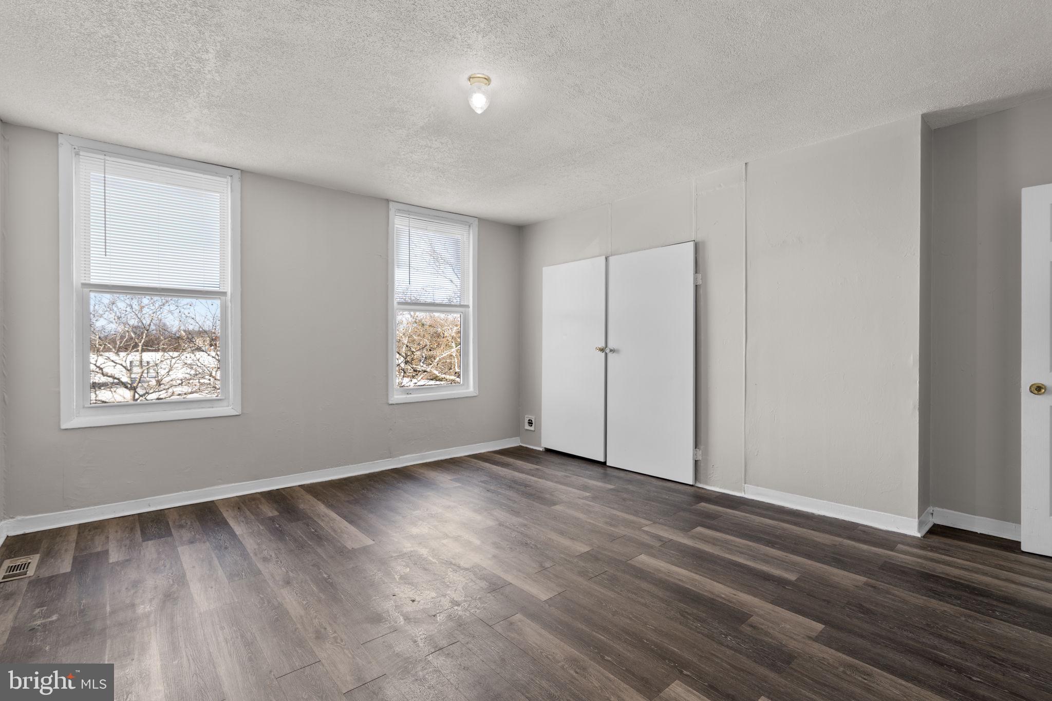 517 Mosher Street Baltimore, MD 21217 - Photo 15 of 45 an empty room with wooden floor and windows
